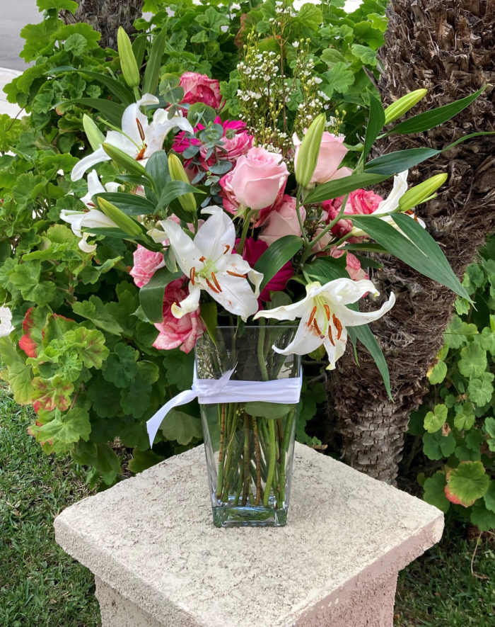 Pink rose, white lilies, daises, and flowers arrangement
