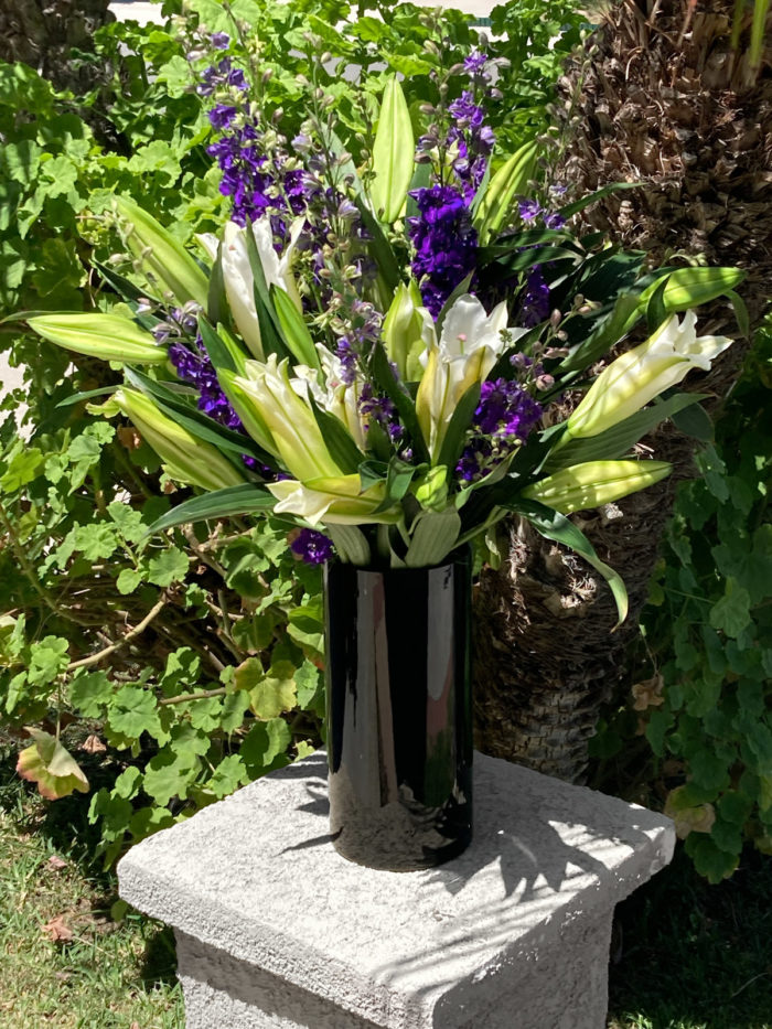 White lilies and purple larkspur floral design arrangement